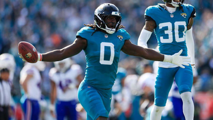 Jacksonville Jaguars linebacker Devin Lloyd (0) celebrates a fumble recovery with cornerback Montaric Brown (30) during the second quarter of an NFL football AFC Wild Card playoff matchup, Sunday, Jan. 11, 2026, in Jacksonville, Fla. [Corey Perrine/Florida Times-Union]