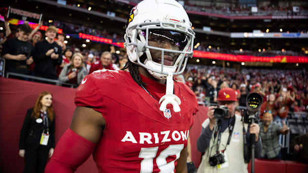 Arizona Cardinals wideout Marvin Harrison Jr. (red uniform) gets ready to head out onto the field.