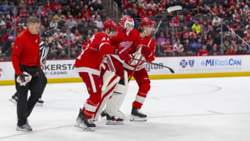 Detroit Red Wings goaltender Ville Husso (35) is helped off the ice after sustaining a lower-body injury