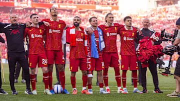 Liverpool's players celebrate their title success in front of the Kop end - but they must wait to get their hands on the Premier League trophy