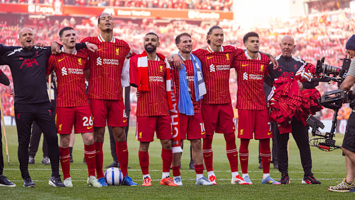Liverpool's players celebrate their title success in front of the Kop end - but they must wait to get their hands on the Premier League trophy