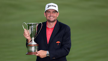 Keegan Bradley poses with the winner's trophy following his victory at the 2025 Travelers Championship