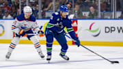 May 20, 2024; Vancouver, British Columbia, CAN; Edmonton Oilers forward Dylan Holloway (55) watches Vancouver Canucks forward Dakota Joshua (81) hanlde the puck during the first period in game seven of the second round of the 2024 Stanley Cup Playoffs at Rogers Arena. Mandatory Credit: Bob Frid-Imagn Images