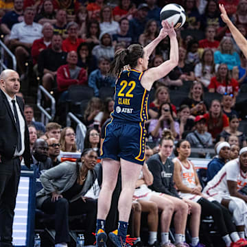 Jun 17, 2025; Indianapolis, Indiana, USA; Indiana Fever guard Caitlin Clark (22) shoots the ball while Connecticut Sun guard Jacy Sheldon (4) defends in the second half at Gainbridge Fieldhouse. Mandatory Credit: Trevor Ruszkowski-Imagn Images