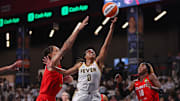 Sep 14, 2025; College Park, Georgia, USA; Indiana Fever guard Kelsey Mitchell (0) shoots past Atlanta Dream center Brittney Griner (42) and guard Rhyne Howard (10) in the third quarter during game one of round one for the 2025 WNBA Playoffs at Gateway Center Arena at College Park. Mandatory Credit: Brett Davis-Imagn Images