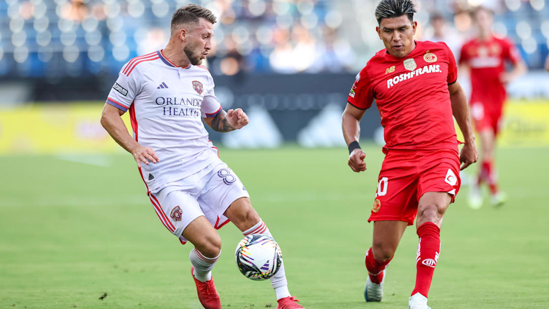 Aug 20, 2025; Carson, California, USA;  Orlando City SC forward Marco Pasalic (87) receives a pass from teammate vs Toluca FC at Dignity Health Sports Park. Mandatory Credit: William Navarro-Imagn Images