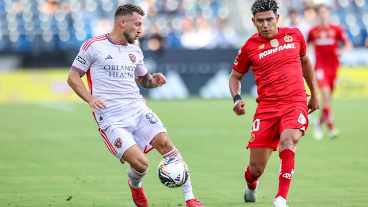 Aug 20, 2025; Carson, California, USA;  Orlando City SC forward Marco Pasalic (87) receives a pass from teammate vs Toluca FC at Dignity Health Sports Park. Mandatory Credit: William Navarro-Imagn Images