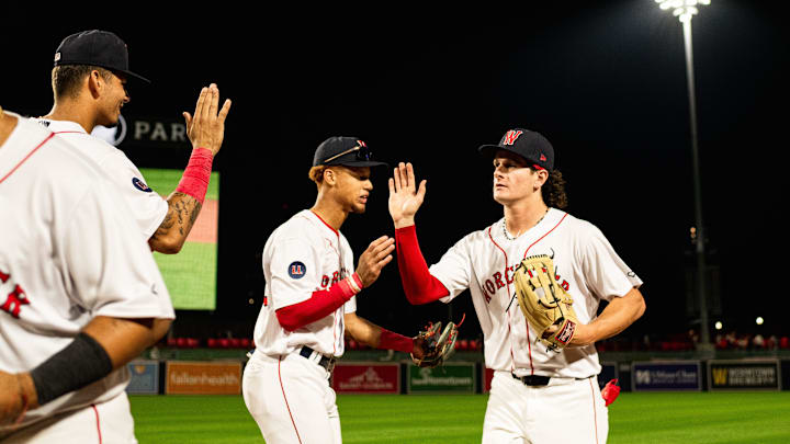 Roman Anthony high fives WooSox teammates following the Triple-A club's 12-2 win over Toledo on Tuesday at Polar Park.