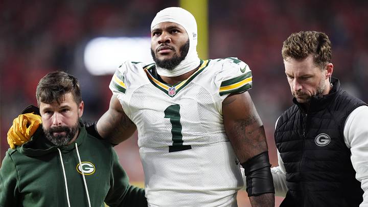 Dec 14, 2025; Denver, Colorado, USA; Green Bay Packers defensive end Micah Parsons (1) walks off the field with help from medical personnel following an injury during the third quarter against the Denver Broncos at Empower Field at Mile High. Mandatory Credit: Ron Chenoy-Imagn Images