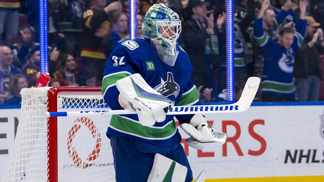 Nov 12, 2024; Vancouver, British Columbia, CAN; Vancouver Canucks goalie Kevin Lankinen (32) celebrates a victory against the Calgary Flames at Rogers Arena. Mandatory Credit: Bob Frid-Imagn Images