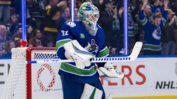 Nov 12, 2024; Vancouver, British Columbia, CAN; Vancouver Canucks goalie Kevin Lankinen (32) celebrates a victory against the Calgary Flames at Rogers Arena. Mandatory Credit: Bob Frid-Imagn Images