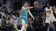 Charlotte Hornets guard LaMelo Ball moves the ball against Miami Heat center Bam Adebayo during the first half at Spectrum Center.