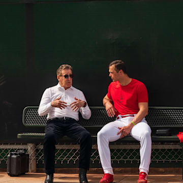 Feb 19, 2023; Tempe, AZ, USA; Los Angeles Angels team owner Arturo  Arte  Moreno (left) speaks with catcher Logan O Hoppe (14) during spring training workouts at Tempe Diablo Stadium. Mandatory Credit: Allan Henry-Imagn Images