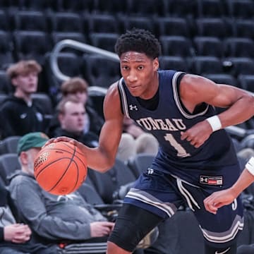 Milwaukee Juneau's Dooney Johnson (1) races Racine Park's Jwan Eastland (11) downcourt during their Deer District Prep Showcase game at Fiserv Forum in Milwaukee, WI. on Saturday, Feb. 8, 2025. Racine Park won the game, 70-55.