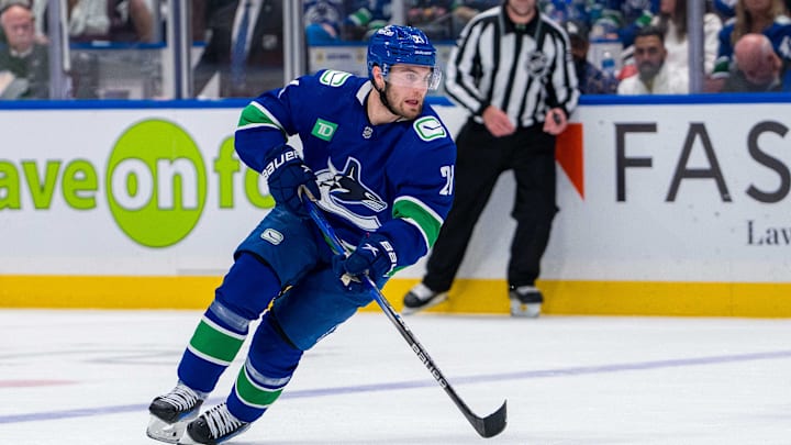 May 10, 2024; Vancouver, British Columbia, CAN; Vancouver Canucks forward Nils Hoglander (21) handles the puck against the Edmonton Oilers during the first period in game two of the second round of the 2024 Stanley Cup Playoffs at Rogers Arena. Mandatory Credit: Bob Frid-Imagn Images May 10, 2024; Vancouver, British Columbia, CAN; Vancouver Canucks forward Nils Hoglander (21) handles the puck against the Edmonton Oilers during the first period in game two of the second round of the 2024 Stanley Cup Playoffs at Rogers Arena. Mandatory Credit: Bob Frid-Imagn Images