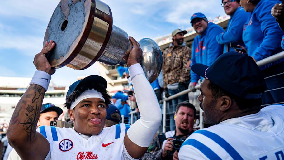 Ole Miss quarterback Trinidad Chambliss hoists the Golden Egg trophy after a win over Mississippi State.