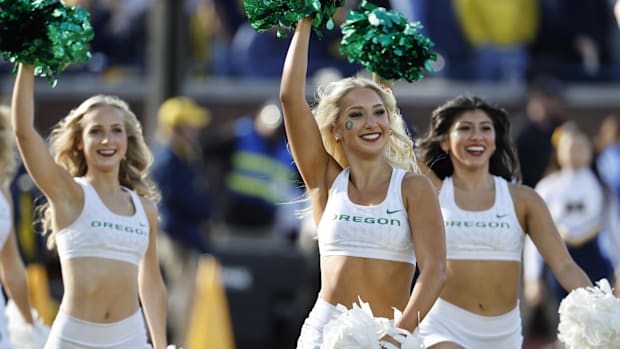 Oregon Ducks cheerleaders celebrate after a score in the first half against the Michigan Wolverines at Michigan Stadium. Mand