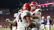 Oct 11, 2025; Auburn, Alabama, USA;  Georgia Bulldogs quarterback Gunner Stockton (14) celebrates a touchdown with offensive lineman Drew Bobo (74) during the fourth quarter against the Auburn Tigers at Jordan-Hare Stadium. Mandatory Credit: John Reed-Imagn Images