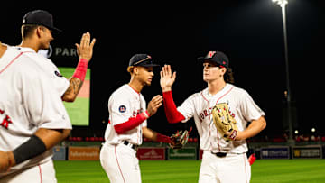 Roman Anthony high fives WooSox teammates following the Triple-A club's 12-2 win over Toledo on Tuesday at Polar Park.