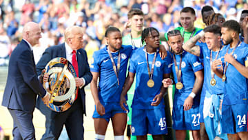Gianni Infantino and Donald Trump hand over the Club World Cup trophy to Chelsea.