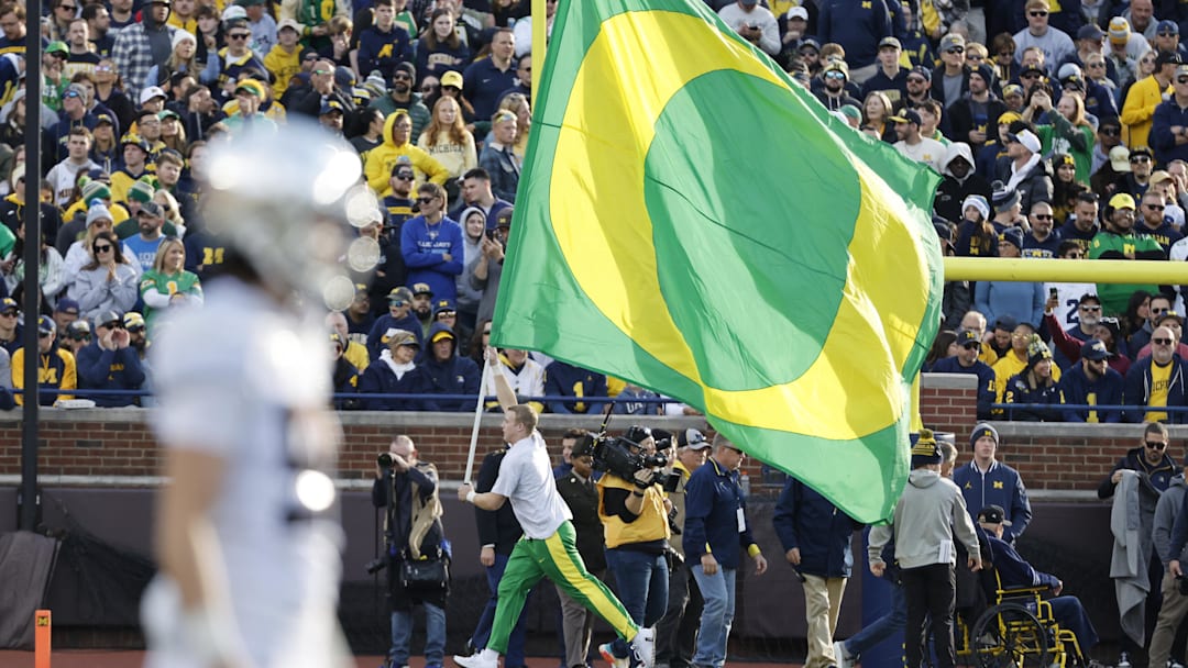 Nov 2, 2024; Ann Arbor, Michigan, USA;  Oregon Ducks cheerleader celebrates a touchdown in the first half against the Michigan Wolverines at Michigan Stadium.