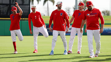 Philadelphia Phillies catcher Garrett Stubbs (21) (left) shortstop Trea Turner (7) (left center) first base Bryce Harper (3) (left center) second base Bryson Stott (5) (right center) and designated hitter Kyle Schwarber (12) (right) participate in spring training workouts at BayCare Ballpark.