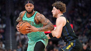 Feb 25, 2025; San Francisco, California, USA; Charlotte Hornets forward Miles Bridges (0) drives against Golden State Warriors guard Brandin Podziemski (2) in the third quarter at the Chase Center. Mandatory Credit: Cary Edmondson-Imagn Images