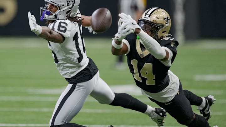 Dec 29, 2024; New Orleans, Louisiana, USA; Las Vegas Raiders wide receiver Jakobi Meyers (16) misses a catch as New Orleans Saints cornerback Kool-Aid McKinstry (14) also attempts to grab it during the third quarter at Caesars Superdome. Mandatory Credit: Matthew Hinton-Imagn Images Dec 29, 2024; New Orleans, Louisiana, USA; Las Vegas Raiders wide receiver Jakobi Meyers (16) misses a catch as New Orleans Saints cornerback Kool-Aid McKinstry (14) also attempts to grab it during the third quarter at Caesars Superdome. Mandatory Credit: Matthew Hinton-Imagn Images