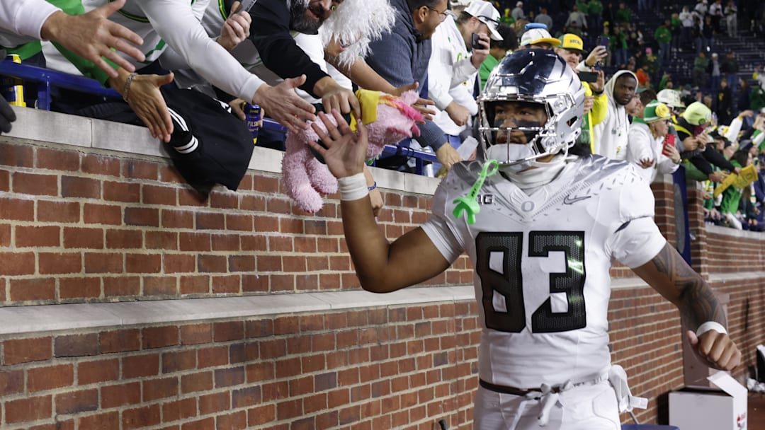 Nov 2, 2024; Ann Arbor, Michigan, USA;  Oregon Ducks tight end Roger Saleapaga (83) celebrates with fans after the game against the Michigan Wolverines at Michigan Stadium. Mandatory Credit: Rick Osentoski-Imagn Images