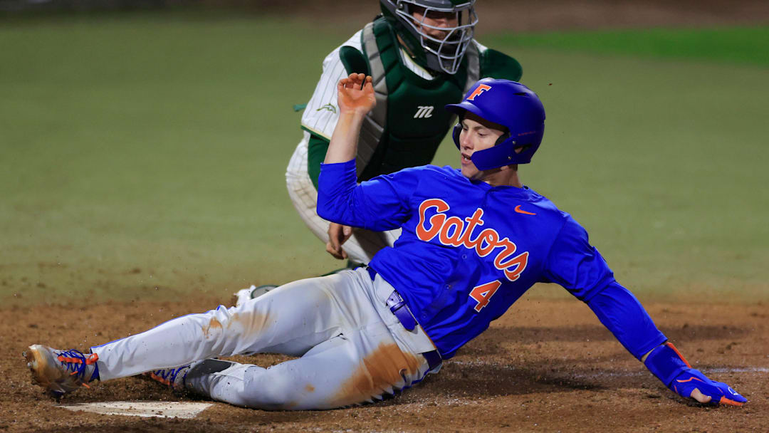 Florida infielder Cade Kurland (4) scores against Jacksonville.