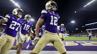 Washington Huskies wide receiver Denzel Boston celebrates after returning a punt for a touchdown.