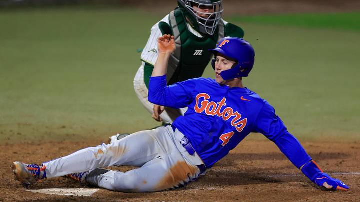 Florida infielder Cade Kurland (4) scores against Jacksonville.