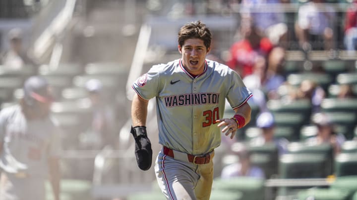 Aug 25, 2024; Cumberland, Georgia, USA; Washington Nationals center fielder Jacob Young (30) reacts after scoring a run against the Atlanta Braves during the ninth inning at Truist Park. 