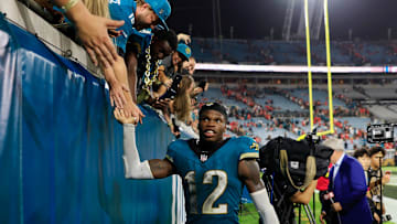 Jacksonville Jaguars wide receiver Travis Hunter (12) high-fives fans after the game of an NFL football matchup at EverBank Stadium, Monday, Oct. 6, 2025, in Jacksonville, Fla. The Jacksonville Jaguars edged the Kansas City Chiefs 31-28. [Corey Perrine/Florida Times-Union]