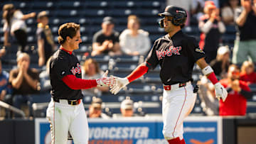 WooSox player Roman Anthony (left) high fives teammate Marcelo Mayer during a Triple-A game at Polar Park on April 23, 2025.
