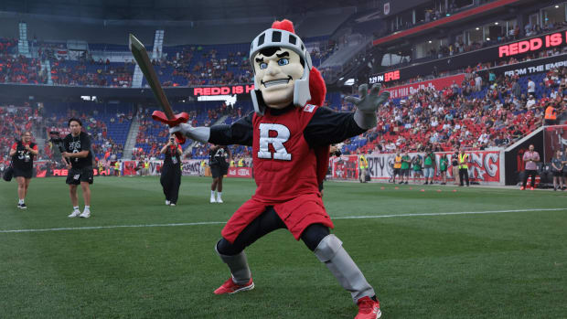 Sir Henry, the Rutgers Scarlet Knight mascot, celebrates the introduction of Redd, the New York Red Bulls new mascot, before 