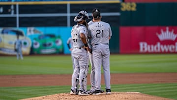 Chicago White Sox pitching coach Ethan Katz (21) comes out to talk with Chicago White Sox starting pitcher Ky Bush (57) during the first inning against the Oakland Athletics at Oakland-Alameda County Coliseum. Mandatory Credit: Neville E. Guard-Imagn Images