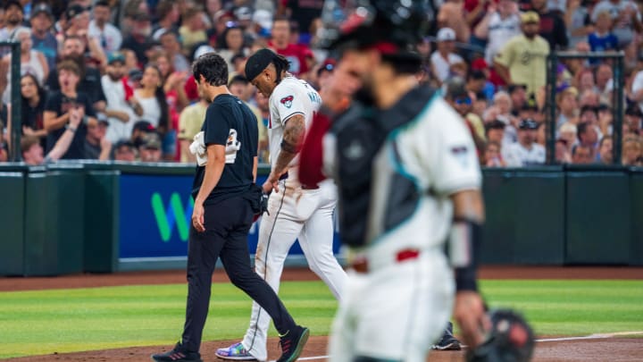 Aug 10, 2024; Phoenix, Arizona, USA; A general view as Arizona Diamondbacks infielder Ketel Marte (4) is escorted off the field after a collision with Philadelphia Phillies catcher Garrett Stubbs (21) (not shown) at second base in the fourth inning during a game at Chase Field. Mandatory Credit: Allan Henry-USA TODAY Sports  