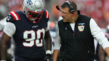 Nov 9, 2025; Tampa, Florida, USA; New England Patriots defensive tackle Christian Barmore (90) talks with head coach Mike Vrabel during the third quarter against the Tampa Bay Buccaneers at Raymond James Stadium.