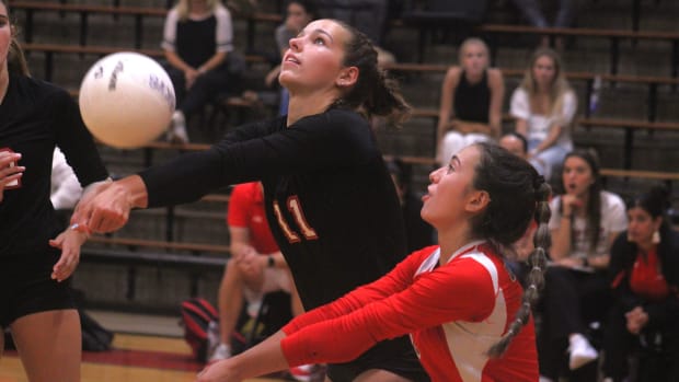 Bishop Kenny's Olivia Ryno (11) and Alexis Sowers (1) lunge for the ball against Bartram Trail during a high school volleybal