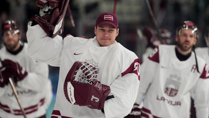 Team Latvia goaltender Elvis Merzlikins salutes the crowd. 
