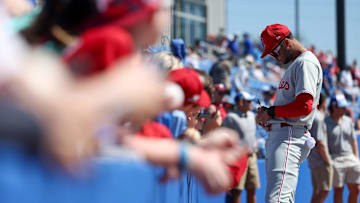 Mar 2, 2025; Dunedin, Florida, USA; Philadelphia Phillies outfielder Justin Crawford (80) signs autographs for fans before a game against the Toronto Blue Jays during spring training at TD Ballpark.