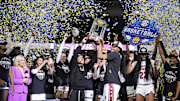 Mar 9, 2025; Greenville, SC, USA;  South Carolina Gamecocks head coach Dawn Staley and forward Sania Feagin (20) hoist the SEC Championship Trophy after her teams win over Texas during the SEC Womenís Tournament at Bon Secours Wellness Arena. Mandatory Credit: Jim Dedmon-Imagn Images