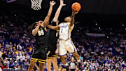 Jan 4, 2025; Baton Rouge, Louisiana, USA;  LSU Tigers guard Jordan Sears (1) drives to the basket against Vanderbilt Commodores forward Devin McGlockton (99) during the first half at Pete Maravich Assembly Center.