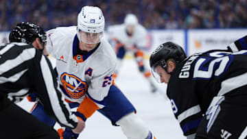 Feb 1, 2025; Tampa, Florida, USA; New York Islanders center Brock Nelson (29) and Tampa Bay Lightning center Jake Guentzel (59) face-off in the first period at Amalie Arena. Mandatory Credit: Nathan Ray Seebeck-Imagn Images