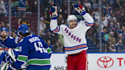 Nov 19, 2024; Vancouver, British Columbia, CAN; Vancouver Canucks defenseman Quinn Hughes (43) watches as New York Rangers forward Chris Kreider (20) celebrates a goal scored by forward Mika Zibanejad (93) during the first period at Rogers Arena. Mandatory Credit: Bob Frid-Imagn Images