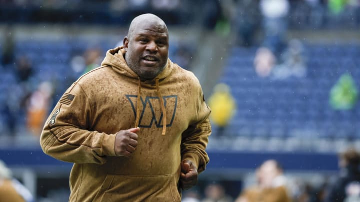 Nov 12, 2023; Seattle, Washington, USA; Washington Commanders offensive coordinator Eric Bieniemy jogs to the locker room following pregame warmups against the Seattle Seahawks at Lumen Field. Mandatory Credit: Joe Nicholson-USA TODAY Sports