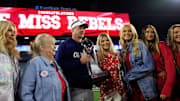Jan. 2, 2025: Ole Miss Rebels head coach Lane Kiffin poses with the Ash Verlander Champions Trophy with his family, including daughter Landry, after the game of the TaxSlayer Gator Bowl.