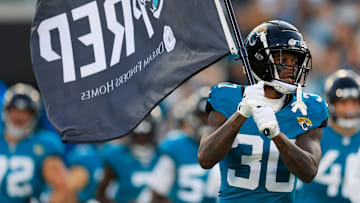 Jacksonville Jaguars cornerback Montaric Brown (30) carries a Jaguars flag onto the field before a preseason NFL football game Saturday, Aug. 17, 2024 at EverBank Stadium in Jacksonville, Fla. The Jacksonville Jaguars defeated the Tampa Bay Buccaneers 20-7. 