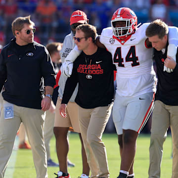 defensive lineman Jordan Hall (44) is helped off the field during the first quarter of an NCAA football game, Saturday, Nov. 1, 2025, at EverBank Stadium in Jacksonville, Fla. [Corey Perrine/Florida Times-Union]